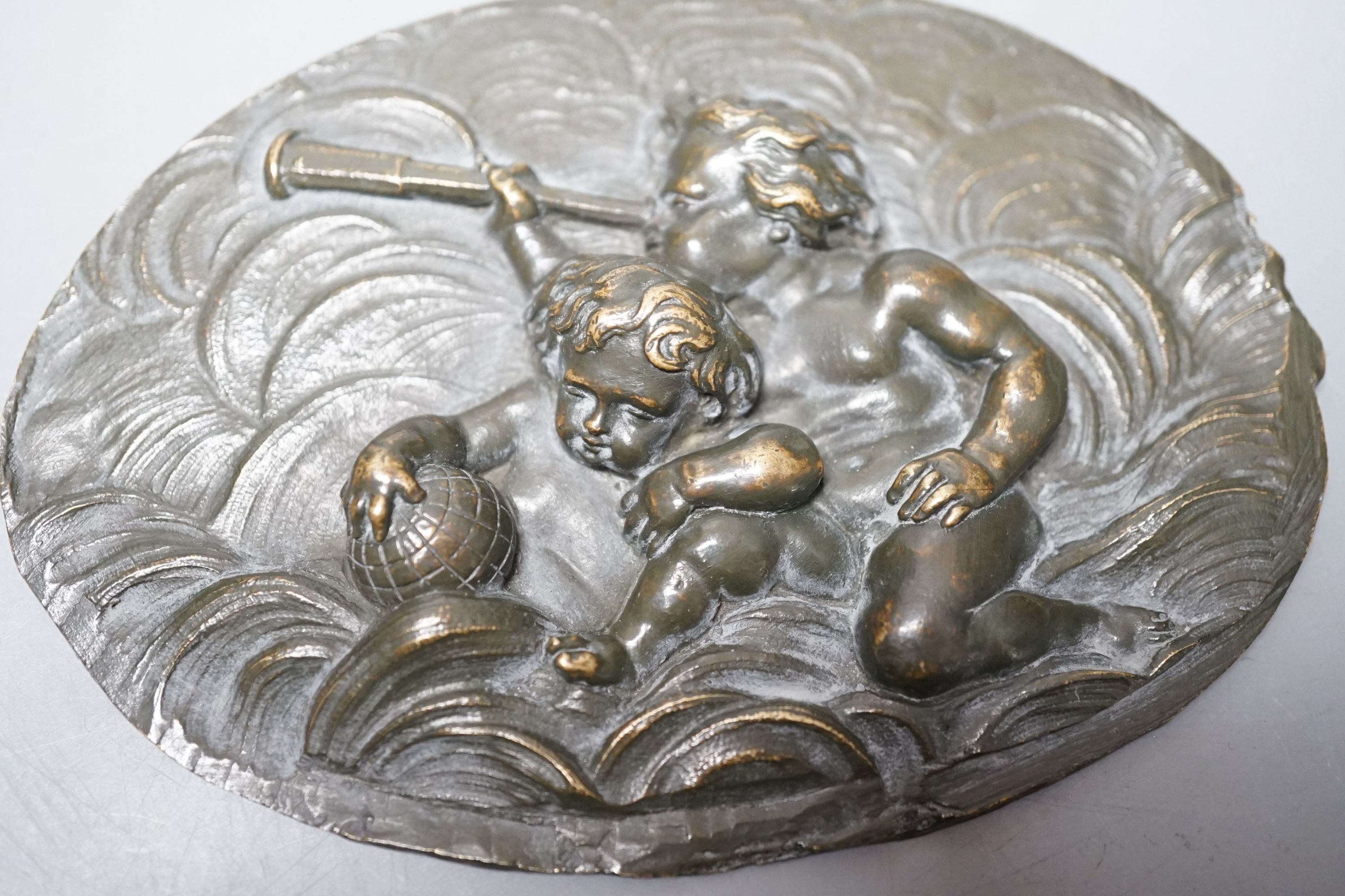 A Renaissance or later bronze 'astronomy' cherub plaque 11.5cm